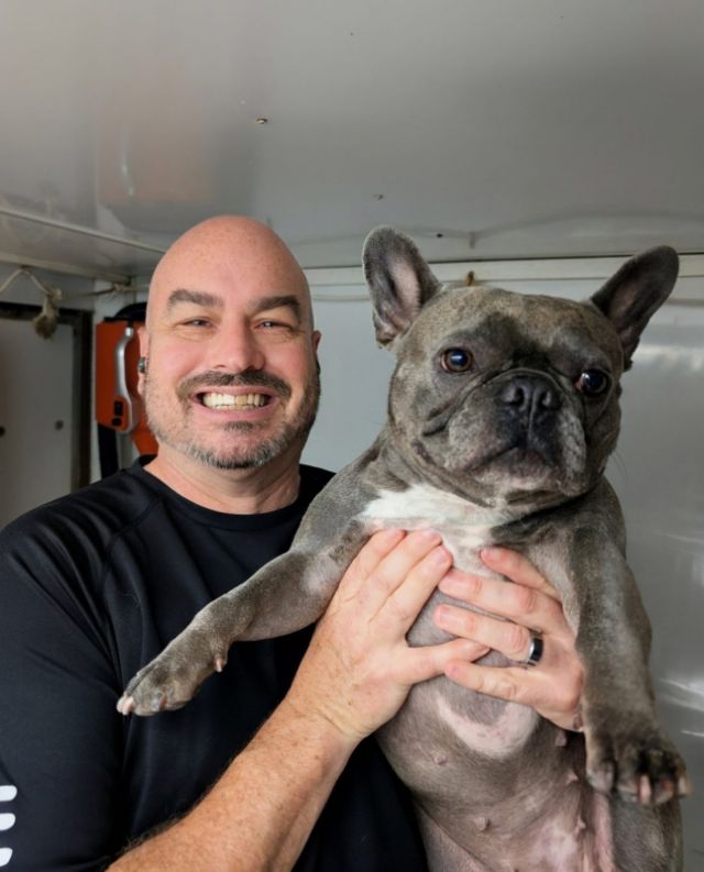Paul holding a French Bulldog after his bath