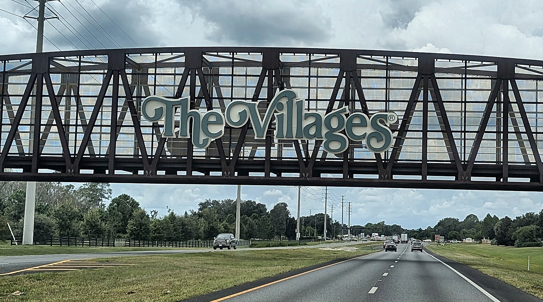 The Villages sign on the bridge over the highway, on the drive in